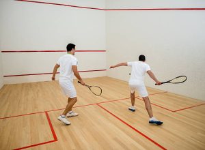 Two men playing squash in the court